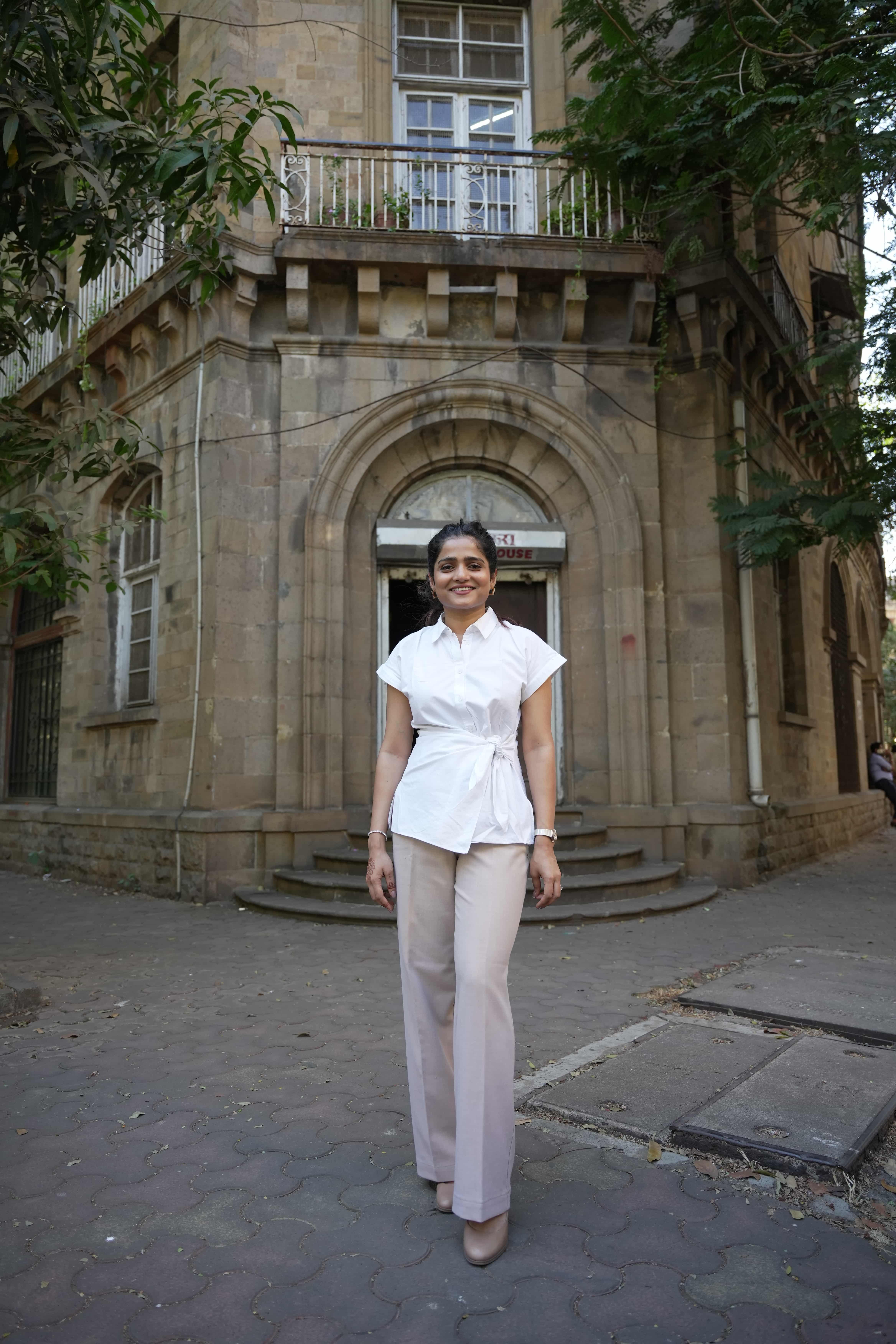 Howden's Ashvita Suvarna posing outside a stone building